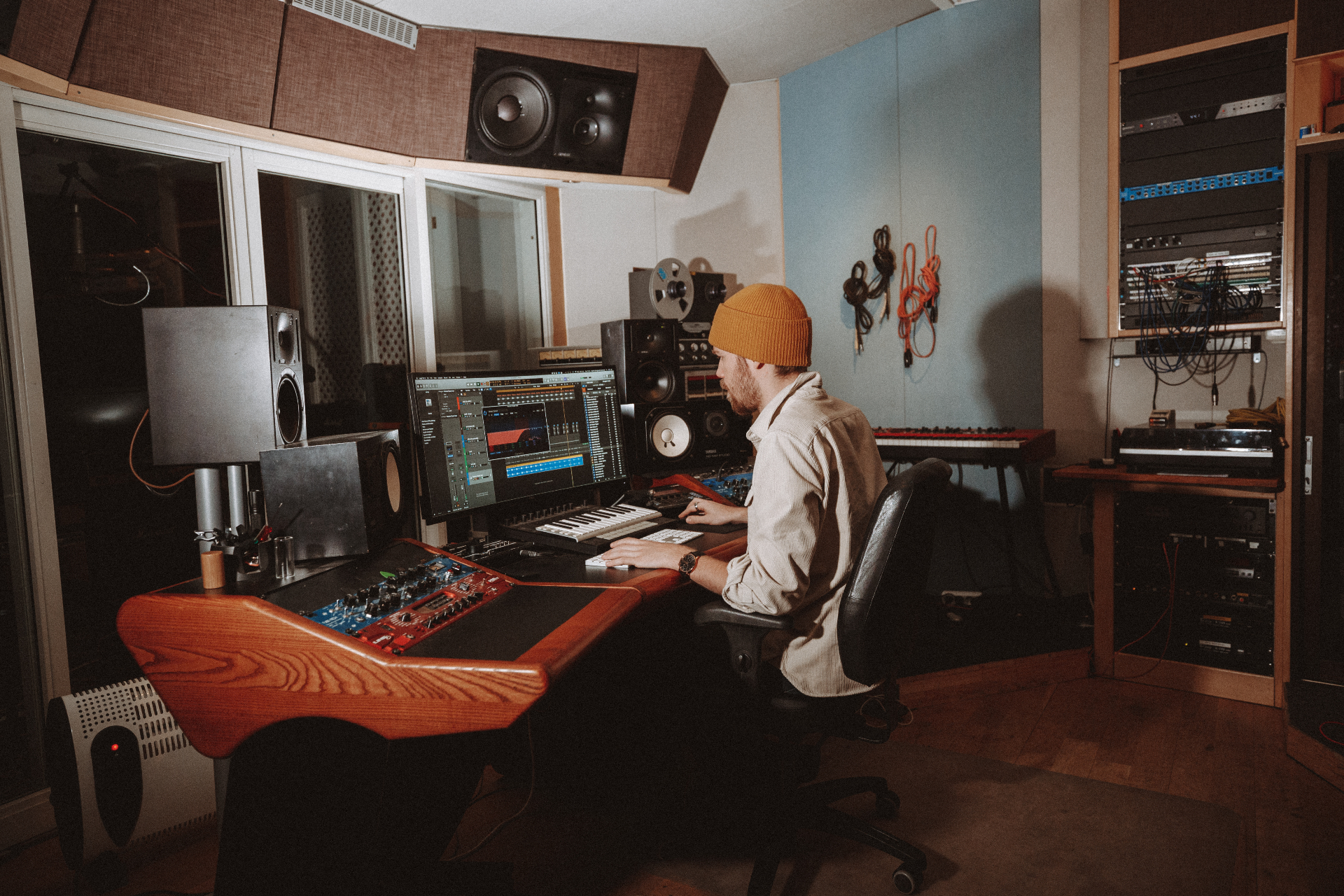 Producer working at the Studio 1 control desk with vintage monitors and outboard