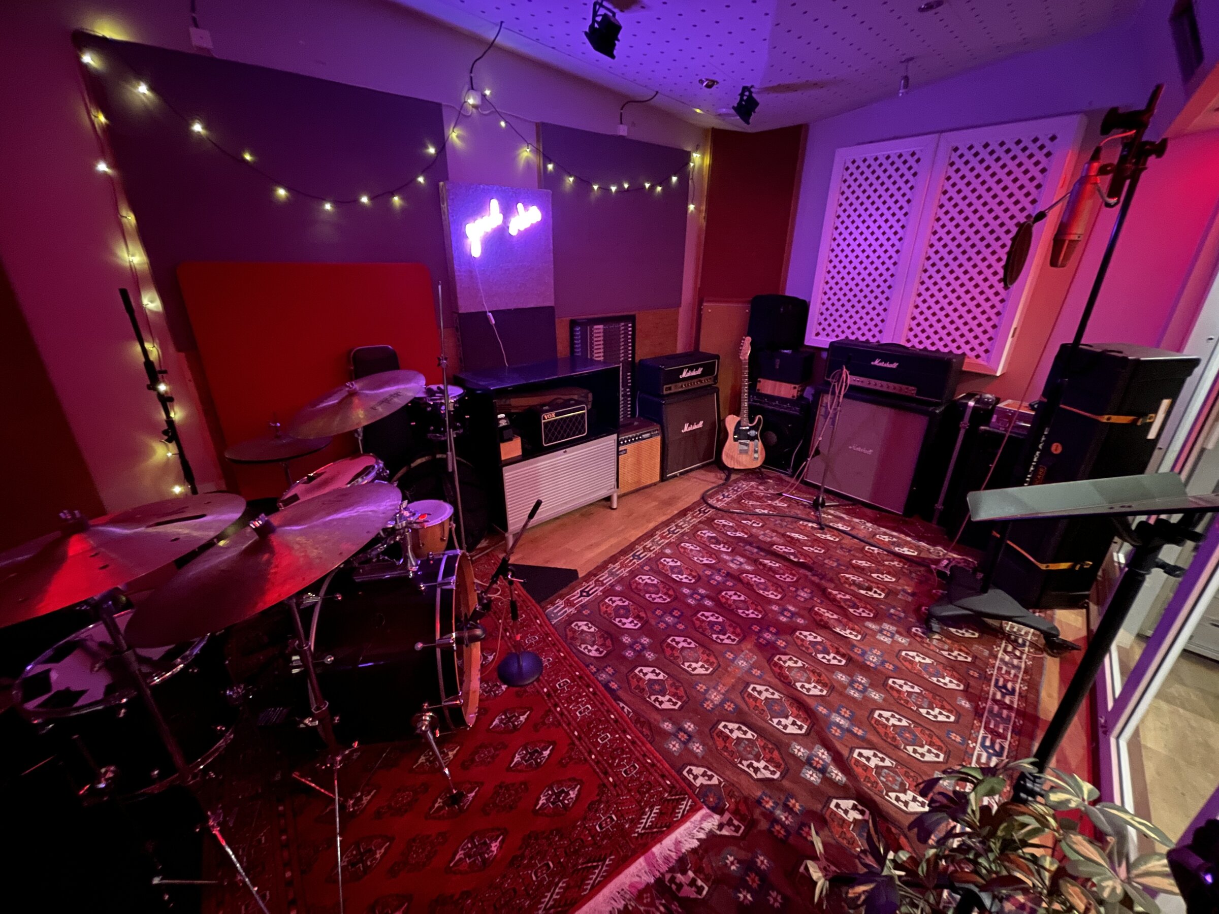 Live room with vintage drum kit, amps and atmospheric lighting